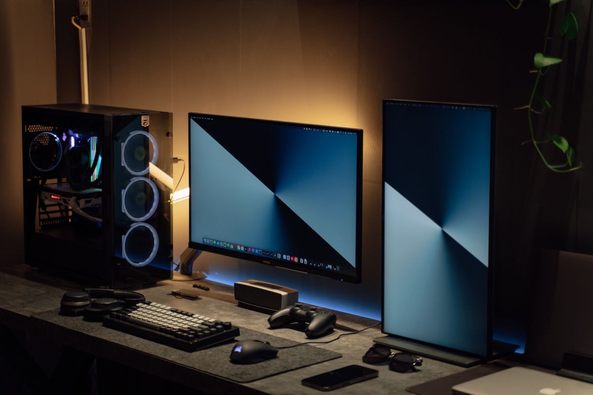Real dual-monitor computer workstation with PC equipment and peripherals