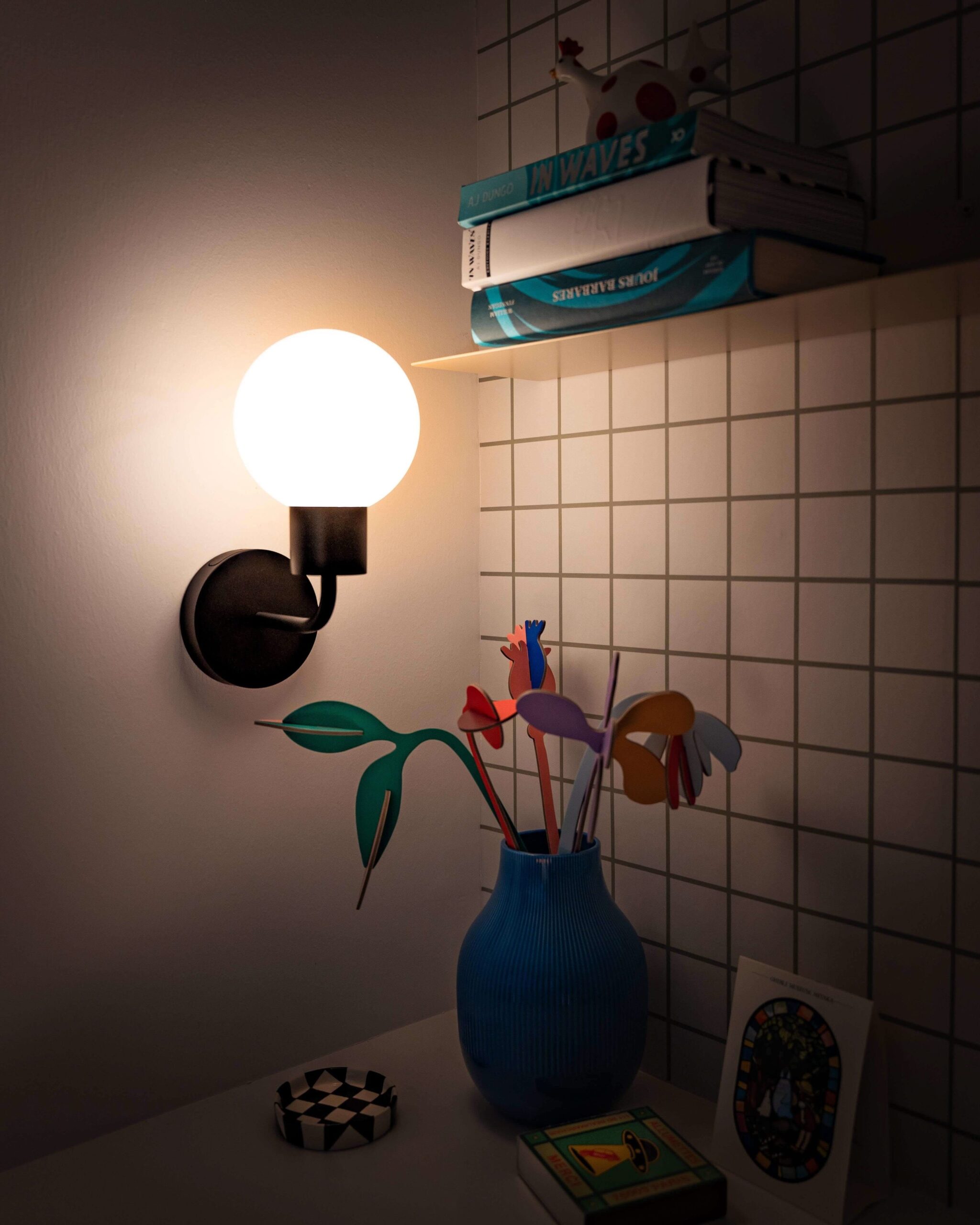 Matte black rechargeable Poplight glowing in a reading area